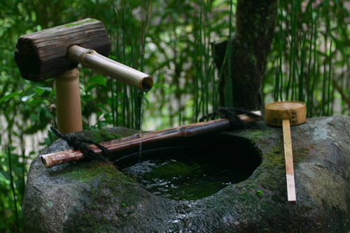 Bamboo pipe and stone basin